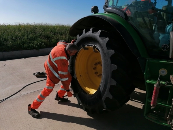 Bushmobile technician fitting tractor rear tyre to a John Deere | Bush Tyres