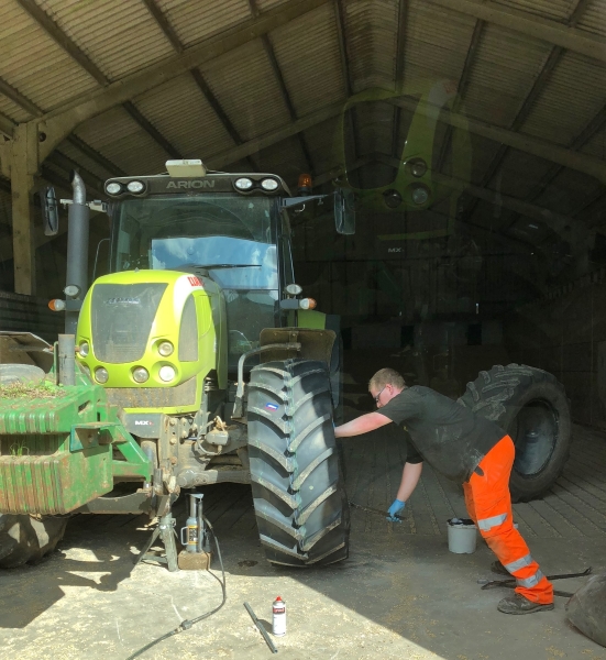 Grimsby Comercials tyre technnician fitting a pair of Mitas AC65 tractor tyres